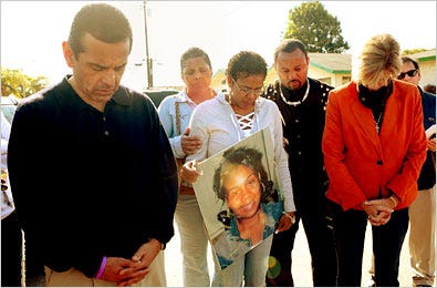 Mayor Antonio R. Villaraigosa of Los Angeles, left, and Charlene Lovett, holding a picture of her daughter, at a rally Saturday calling for unity.