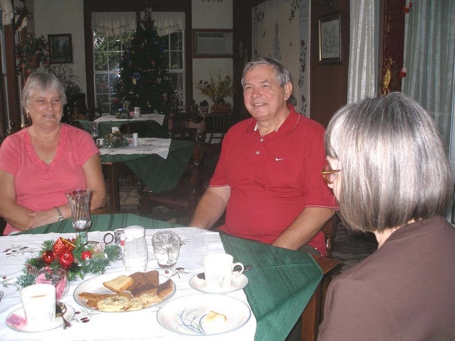 Christa and Gerhard Gross, left, talk with an overnight guest at their bed and breakfast.