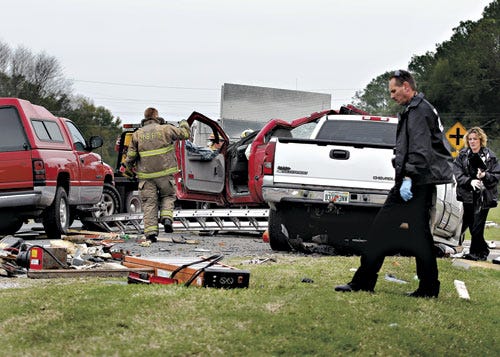 High Springs Police Officer Chuck Harper surveys a three-vehicle accident on U.S. 441 in High Springs that occurred around 1 p.m. Wednesday. Police reported finding quantities of cocaine in and around one of the vehicles.