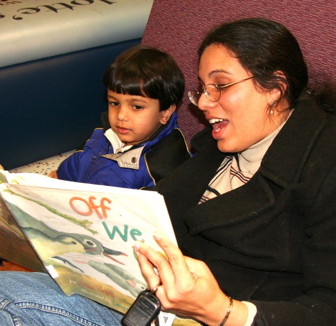 Upasana Pendkar reads to her son Prem, 2, yesterday at the Franklin library.