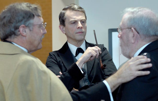 "Sherlock Holmes," center, portrayed by John Sherwood listens intently during a conversation with David McCallister, left, and James McDonald at The Live Oak Public Libraries Foundation's annual fundraising gala Thursday evening at the Bull Street Library.