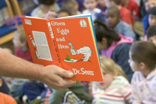 Tom Whatley, education director at the Ocala Civic Theatre, reads "Green Eggs and Ham" by Dr. Seuss to the kindergartner students at Hammett Bowen Elementary School in Ocala as part of OCT's reading advocacy initiative, "Seuss on the Loose."
