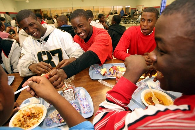 From left, Edrick Jenkins, 14, Tony Hinton, 14, Marquise Murphy, 16, D'Marlo Dismukes, 14, and Kenneth Banks eat lunch at Westlawn Middle School on Wednesday.
