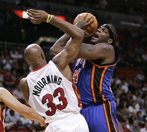 Miami Heat center Alonzo Mourning (33) stops New York Knicks' Eddy Curry (34) from taking a shot in the first half of a basketball game Monday, Jan. 22, 2007, in Miami.