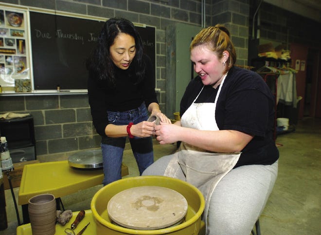 Joni Oye-Benintende, left, helps Meghan Williams, 23, a senior at ESU, in pottery studio at East Stroudsburg University Thursday morning.