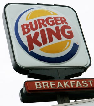A Burger King sign is seen in Bethel Park, Pa., in November. The company has forecast double-digit profit growth for fiscal 2007.
