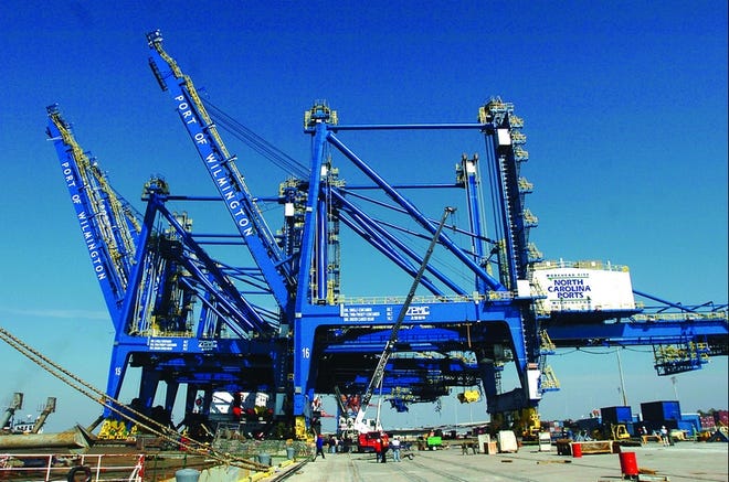The first (closest to camera) of four huge container cranes that were delivered to the Port of Wilmington is offloaded Wednesday from the 'Zhen Hua 16,' the ship that brought them from Shanghai, China.