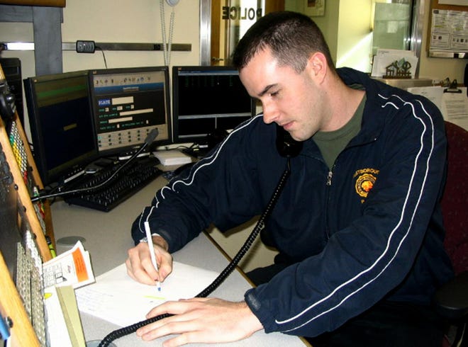Dispatcher Timothy Charland fields a call at the Westborough Police station.
