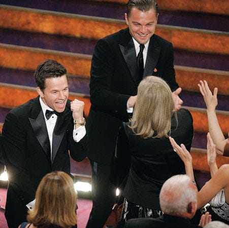 Leonardo DiCaprio, right, celebrates with Mark Wahlberg, left, and cast members after the film "The Departed" won best motion picture of the year at the 79th Academy Awards on Sunday in Los Angeles.