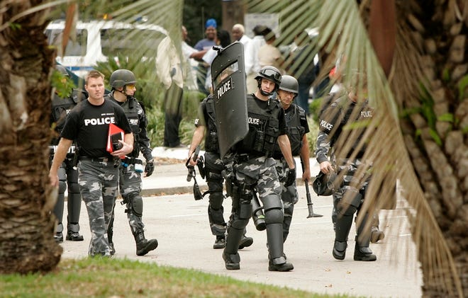 Members of the Gainesville Police SWAT team leave the scene of a standoff at a local motel late last year.