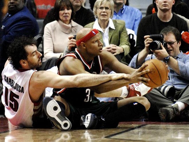 Toronto's Jorge Garbajosa (left) battles Milwaukee's Charlie Villanueva for the basketball.