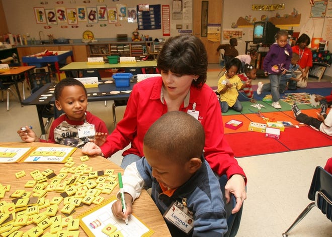 Teacher Vicki Reece helps Joe Crutchfield, 5, left, and Lennox Petty, 6, during a pre-K class at Oakdale Primary on Tuscaloosa on Friday afternoon.