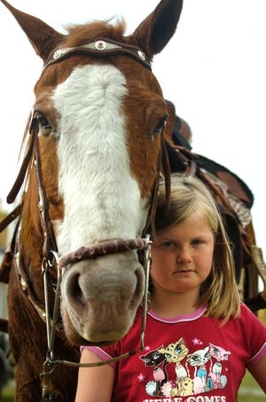 Maddy Hanners and her horse, Dirt, placed fourth in a barrel racing competition in July.