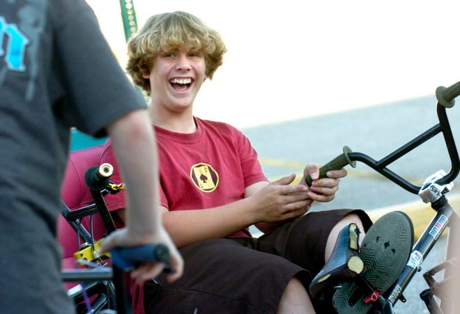 Dustin Poole, 14, laughs with friends as they practice tricks in a parking lot in North Port on Wednesday, March 7, 2007.