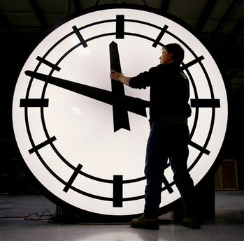 Electric Time machinist Scott Gow prepares to remove the hands of an eight-foot clock being shipped to the Ashley Furniture company in Kenosha, Wis., at the Electric Clock factory in Medfield Mass., Friday morning, March 9, 2007. Daylight saving time begins Sunday morning March 11, 2007, three weeks earlier than it has for the past two decades due to a 2005 law taking effect this year.