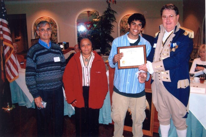 Vishal Sancheti, 17, a junior at Lakewood Ranch High School, won the Knight Essay Contest, sponsored annually by the Saramana Chapter of the Sons of the American Revolution. His award was presented at the George Washington Birthday Celebration. From left are his parents, Vinod and Lata Sancheti; Vishal; and chapter President Philip Tarpley.