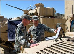 Lt. Col. Douglas Crissman, commander of the 2nd Battalion, 7th Infantry Regiment of the 3rd Infantry Division of the U.S. Army, right, briefs the top U.S. military commander in Iraq, Gen. David Petraeus.