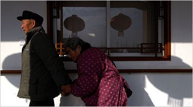 A couple, part of China’s growing retiree population, walked through a home for the elderly in Nanjing.
