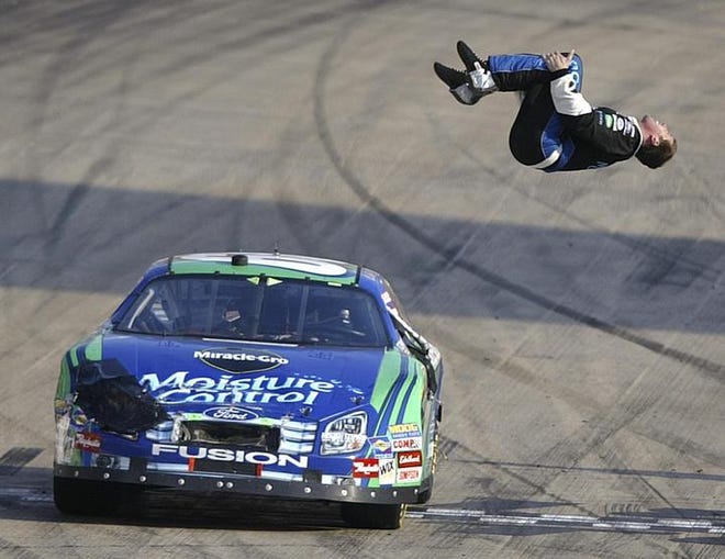 Carl Edwards does a flip at the finish line after winning the Sharpie Mini 300 in Bristol, Tenn. He used a free pit stop after a mistake with the pit row lights to get his first win of the season.
