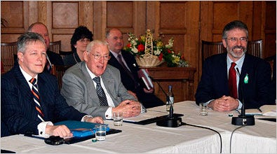 The Rev. Ian Paisley, center, the Protestant leader, and Gerry Adams, right, of Sinn Fein, held a joint news conference to announce their power-sharing agreement. Longtime enemies, the two did not shake hands.
