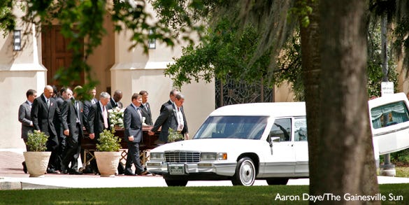 Pallbearers carry out the casket of Tom Jones the former UF women's track coach who died on Wednesday, March 21 after a long battle with cancer at the conclusion of the funeral services at Trinity United Methodist Church on Tuesday, March 27. He was 62 years old.
