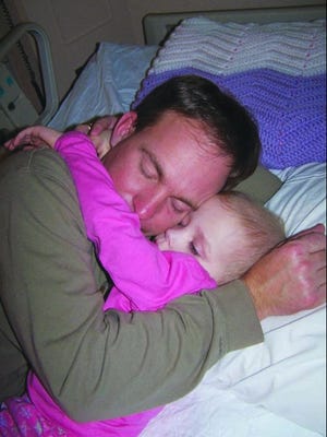 Emily hugs her father after her first round of chemotherapy.