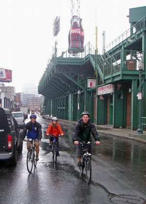 Ed Ballo, Amy Gallagher and Andrew Prescott didn't have to worry about dodging fly balls as they rode under the coveted Monster Seats at Fenway Park during a unique bike excursion.