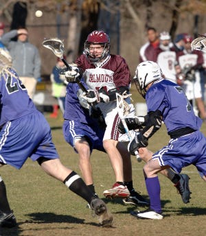 032807rs01 Falmouth's Terrance Dineen fires a shot past #7 Kraig Montgomery for Bourne Thursday afternoon at Falmouth. lacrosse Cape Cod Times photo by Ron Schloerb 3/28/07