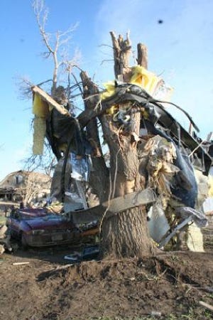 Steel girders from a mobile home are shown wrapped around a tree, Thursday, March 29, 2007, in Holly,Colo. A woman who lived in the trailer died of injuries sustained when a tornado destroyed the trailer Wednesday night. (AP Photo/The Lamar Ledger)