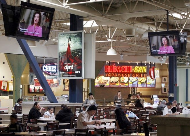Shoppers at this California mall can watch high-definition TVs while eating in the food court.