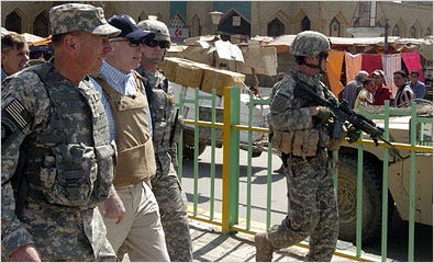 Senator John McCain, Republican of Arizona, in baseball cap, visited the Shorja market in Baghdad on Sunday with Gen. David H. Petraeus, left, the commander of the American forces in Iraq, accompanied by military escorts. Mr. McCain led a Congressional delegation on the visit.