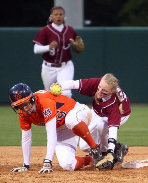 Alabama’s Lauren Parker tags out Auburn’s Krista Klein at second base in the first game of Friday’s doubleheader at the University Softball Complex.