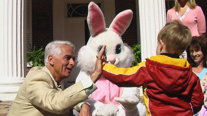 Gov. Charlie Crist gives a high-five to a little boy at an Easter egg hunt at the Governor's Mansion on Saturday.