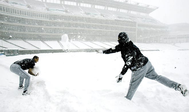 Seattle Mariners' Jose Lopez, left, throws snow at Mariners third base coach Carlos Garcia at Jacobs Field, Sunday, April 8, 2007, in Cleveland. For the second day in a row, snow and cold weather forced a doubleheader between the Mariners and Cleveland Indians to be postponed. (AP Photo/Tony Dejak)