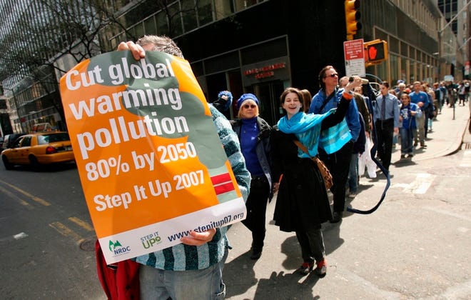 Participants with the "Sea of People" project march through lower Manhattan during the Step It Up 2007 rally in New York on Saturday. More than 1,300 events were organized in every state under the Step It Up banner Ñ a call for Congress to require an 80 percent reduction in carbon dioxide emissions by 2050.