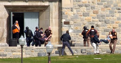 Injured occupants are carried out of Norris Hall at Virginia Tech in Blacksburg, Va. A gunman opened fire in a dorm and classroom on the campus, killing at least 32 people in the deadliest shooting rampage in U.S. history.