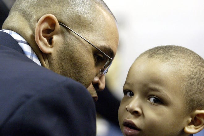 Pastor John C. Williams whispsers to his son Jalen, 3, on the altar during his installation services at the Morningstar Pentecostal Church in Harlem on Saturday, April 14, 2007.
