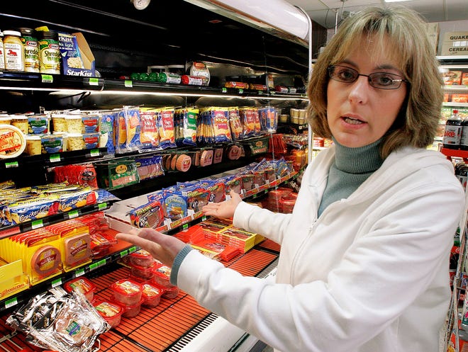 **ADVANCE FOR WEEKEND EDITIONS, APRIL 21-22** Ellie Dorchincez, co-owner of Farm Fresh in Benton, Ill., is seen at her small grocery store, on March 5, 2007. Dorchinecz has seen her electric rates more than double and has been trying to figure out ways to cut costs after Illinois 10-year freeze on electric rates expired in January 2007. (AP Photo/Seth Perlman)
