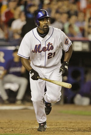 New York Mets' Carlos Delgado watches his seventh inning two-run home run off Colorado Rockies' Bobby Keppel as he trots the bases in their baseball game at Shea Stadium in New York, Monday, April 23, 2007. (AP Photo/Kathy Willens)