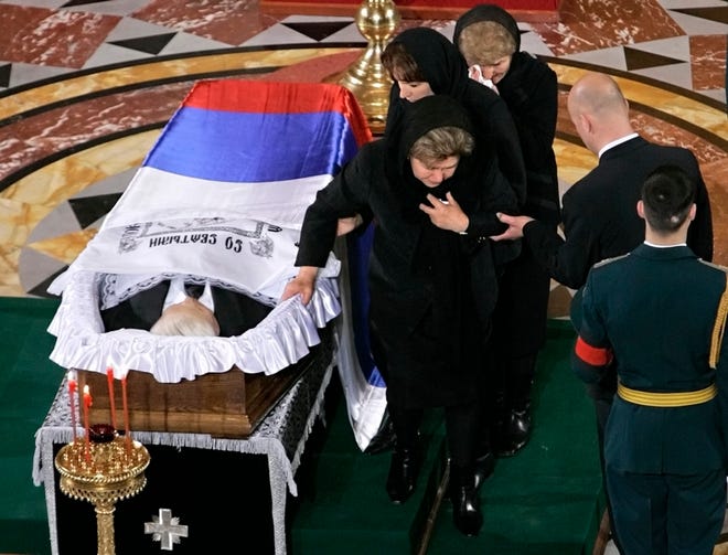 Honor guards stand by the coffin of former Russian president Boris Yeltsin during a farewell ceremony in Moscow, with Yeltsin's widow Naina stepping away.