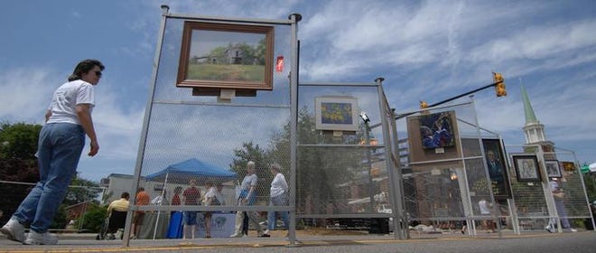 Kathleen Kennedy, of Belvedere, explores the artwork that was set up for public viewing along the streets of downtown North Augusta for Saturday's festival.