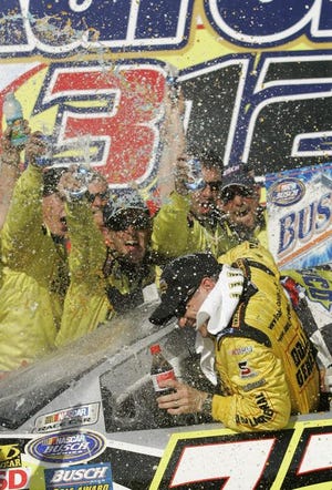 Bobby Labonte's crew congratulates him after his Busch series race victory over teammate Tony Stewart.