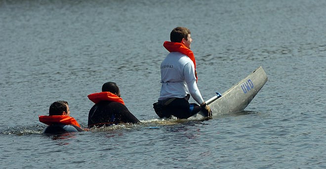 The UMass Dartmouth entry in the Concrete Canoe Competition, with Peter Kotowski in the bow , Joseph Chaperon in the middle and Matt Gagnon in the stern sinks during the first race of the day Saturday at Cochituate State Park. Eleven colleges from New England and one from Quebec competed in canoes that they designed and built using primarily concrete.