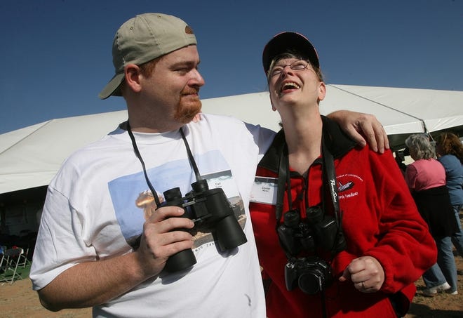 Carl Turner, left, and Crystal Warren, siblings of Alfred Turner, watch as his ashes, and those of about 200 others, are launched on a rocket into suborbital space in Upham, N.M., Saturday. Below, the Spaceloft SL-2 rocket streaks skyward from Spaceport America.