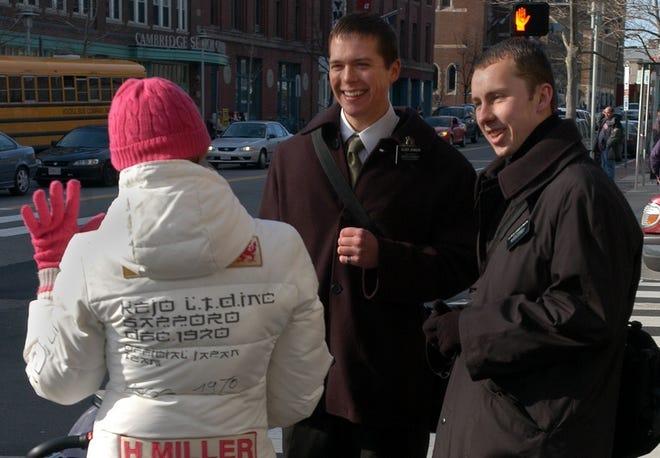 Mormon missionaries greet a pedestrian in Cambridge, Mass., in this 2006 file photo. Two PBS series, "Frontline" and "American Experience," join forces for "The Mormons," a four-hour documentary that airs at 9 p.m. Monday and Tuesday.