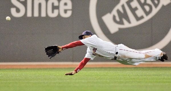 Red Sox center fielder Coco Crisp makes a diving catch on Todd Walker’s bid for a hit in the seventh last night.