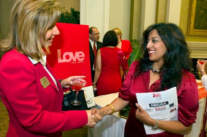 Priya Ghumman - right, the chairwoman of the American Heart Association's inaugural Marion County Go Red For Women Luncheon - greets Julie Landry, of Regions Morgan Keegan, during a fundraising event Wednesday at Golden Ocala Golf & Equestrian Club.
