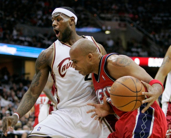 Cleveland's LeBron James, left, draws a charge from New Jersey's Richard Jefferson in Game 1 of their series.