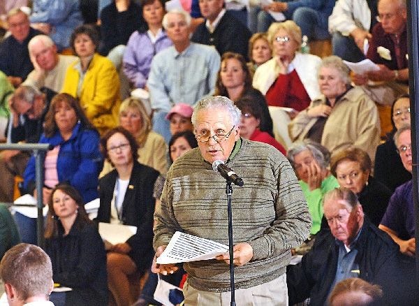 Russ Maloney addresses the medical expenses on the budget at town meeting last night at Mashpee High School.