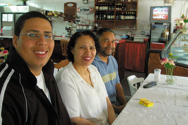 The Pires family, Tony Jr., left, his mother, Dulceneia, and her husband, Antonio, will be serving up a pre-Mother’s Day, Cape Verdean-style pig roast this Saturday at their Whittenton restaurant, TJ’s Diner.